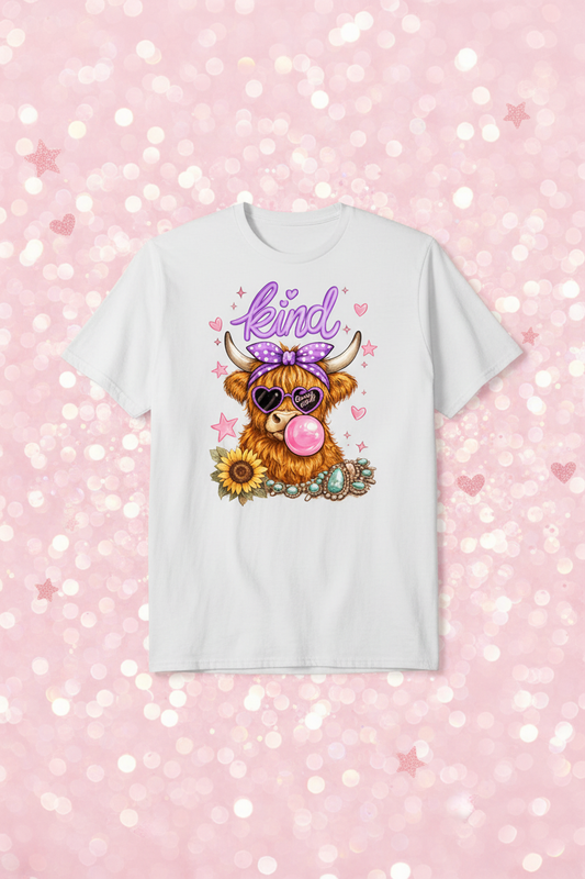 Cute highland cow kind graphic tee on soft pink glitter sparkle background